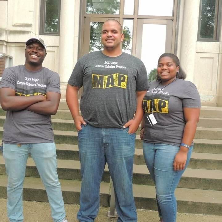 Three adults smiling for the picture