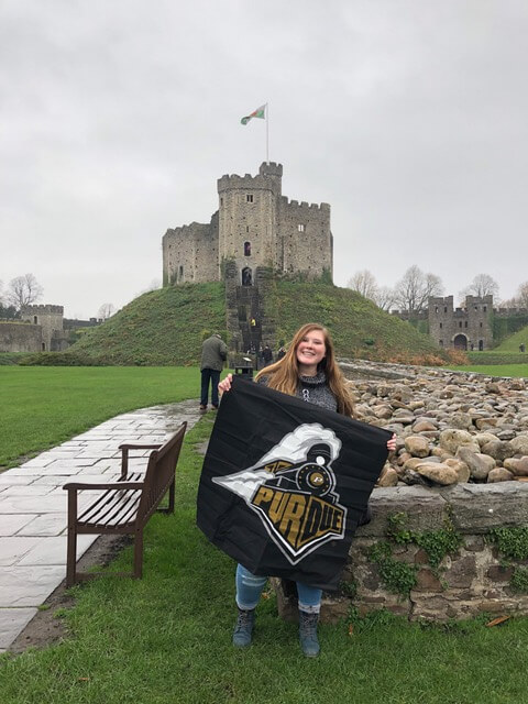 Student holdin a Purdue flag