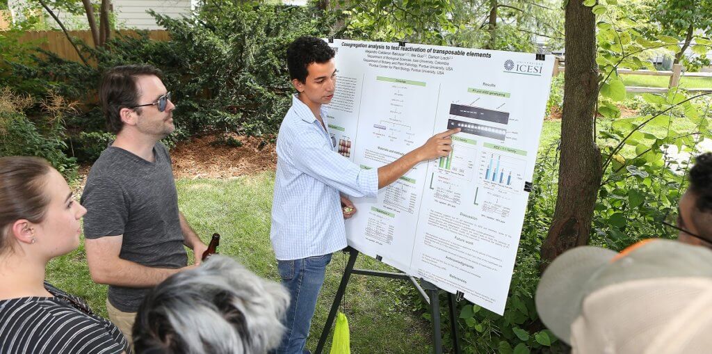 student presenting poster outdoors