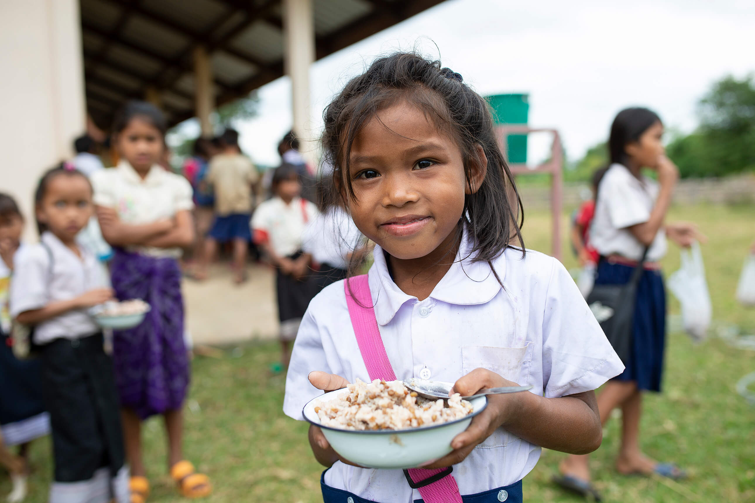 Children eat lunch at a school in Laos.