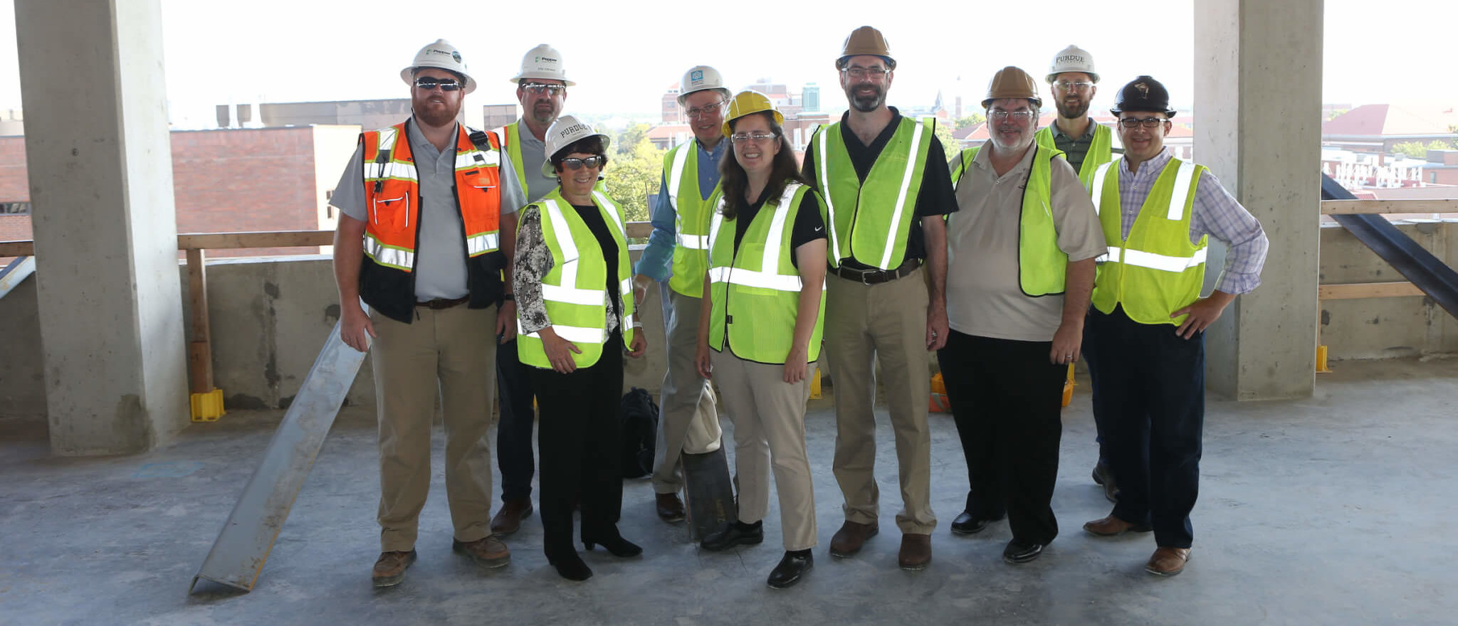 group of people wearing industrial helmets outdoors