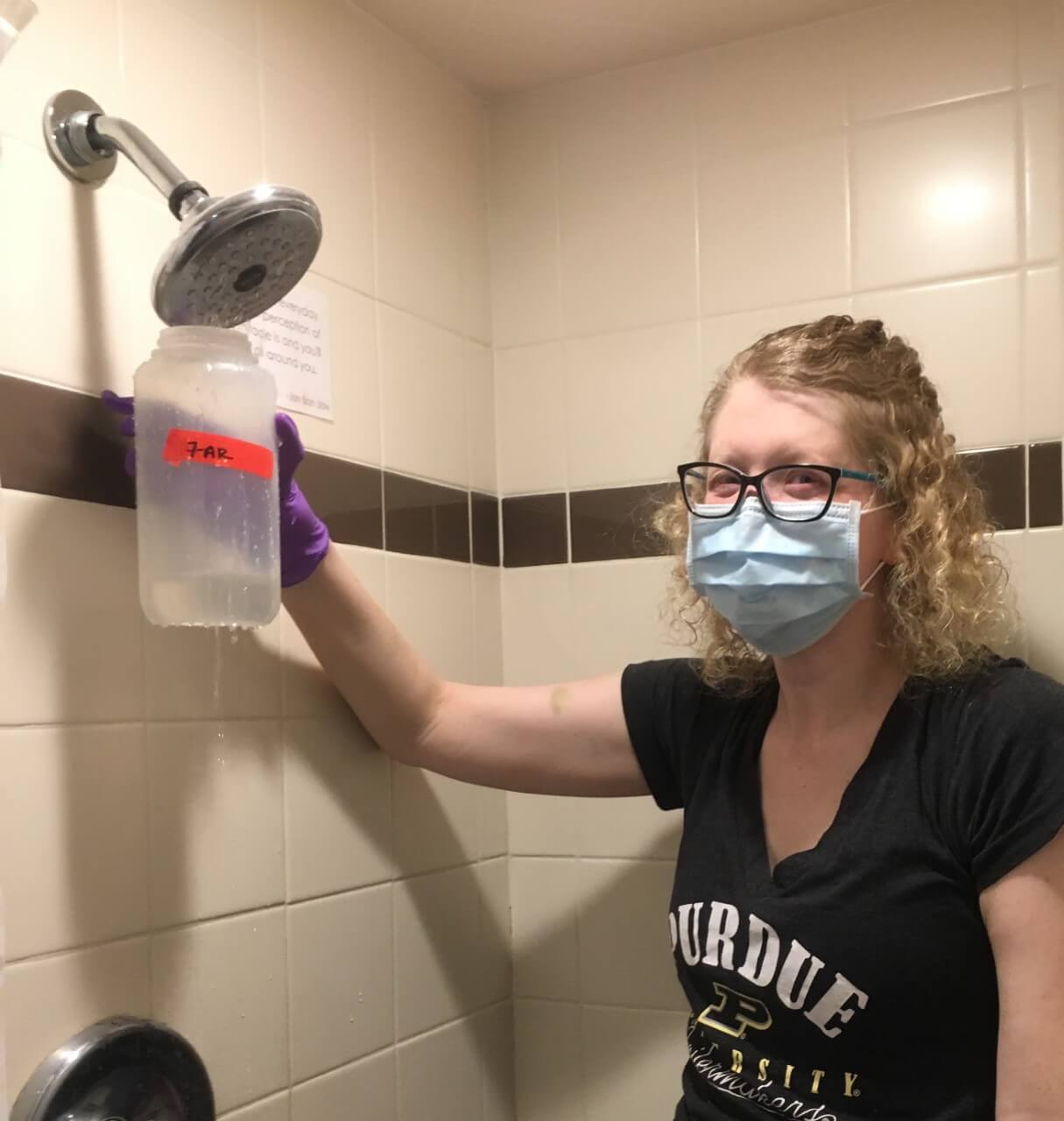 Proctor collects water samples as part of her research.