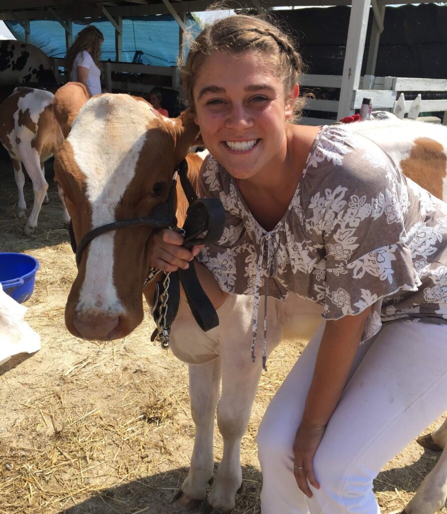 Kylei with a cow in the farm