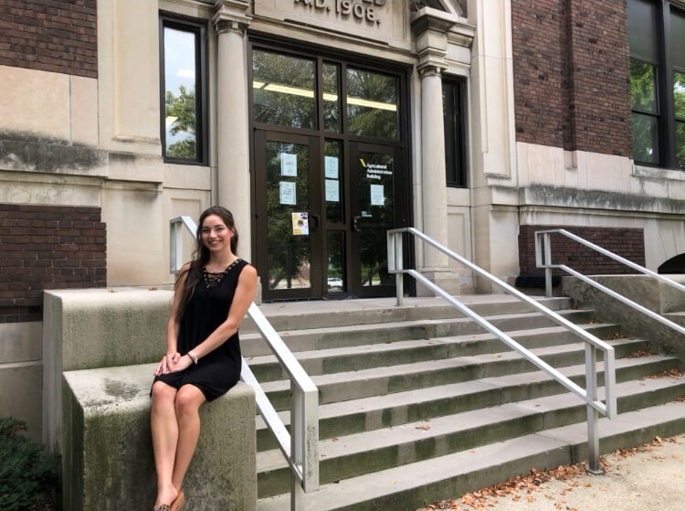 Young lady outside a building on Purdue campus