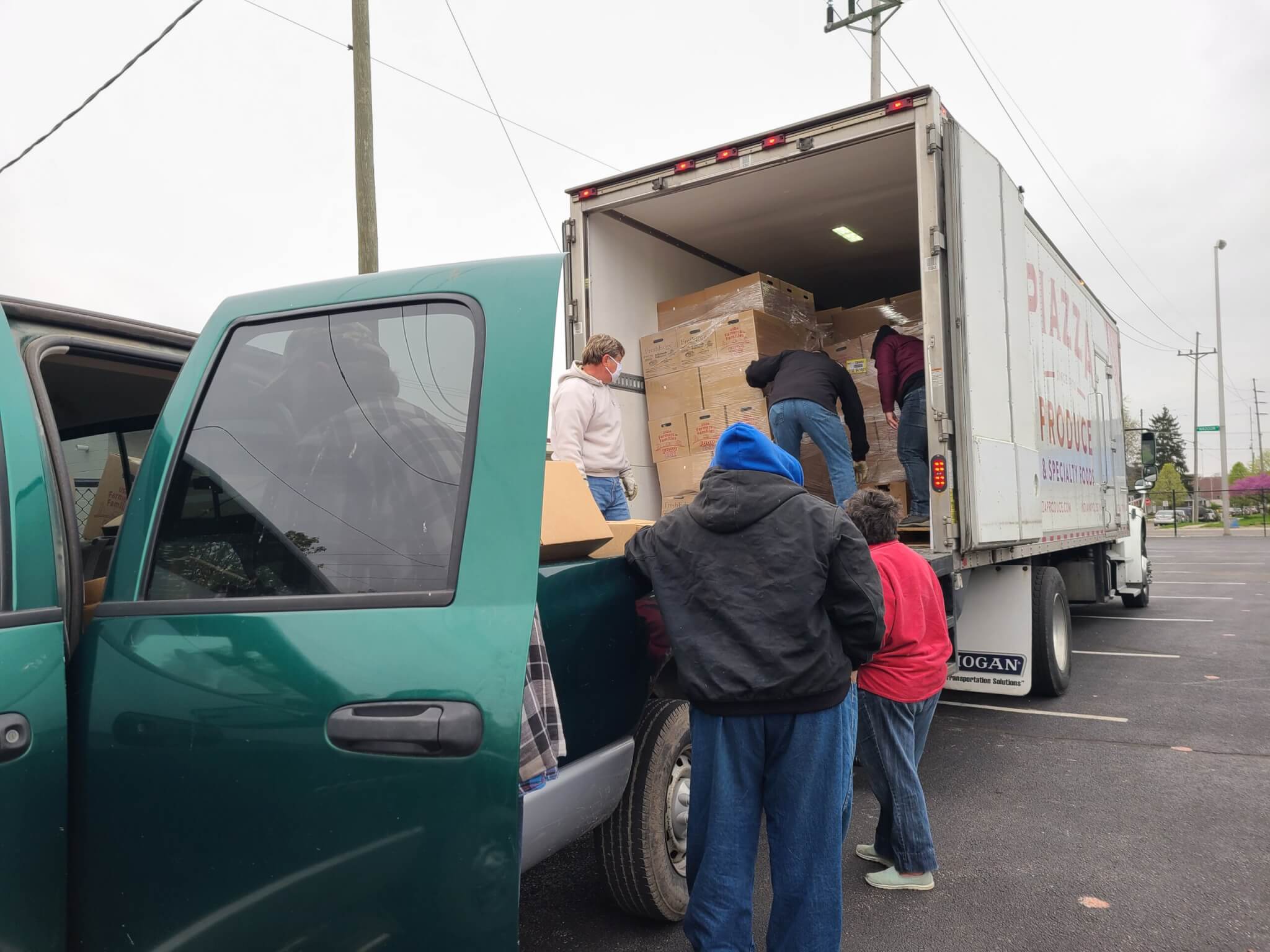 People getting box of food from truck