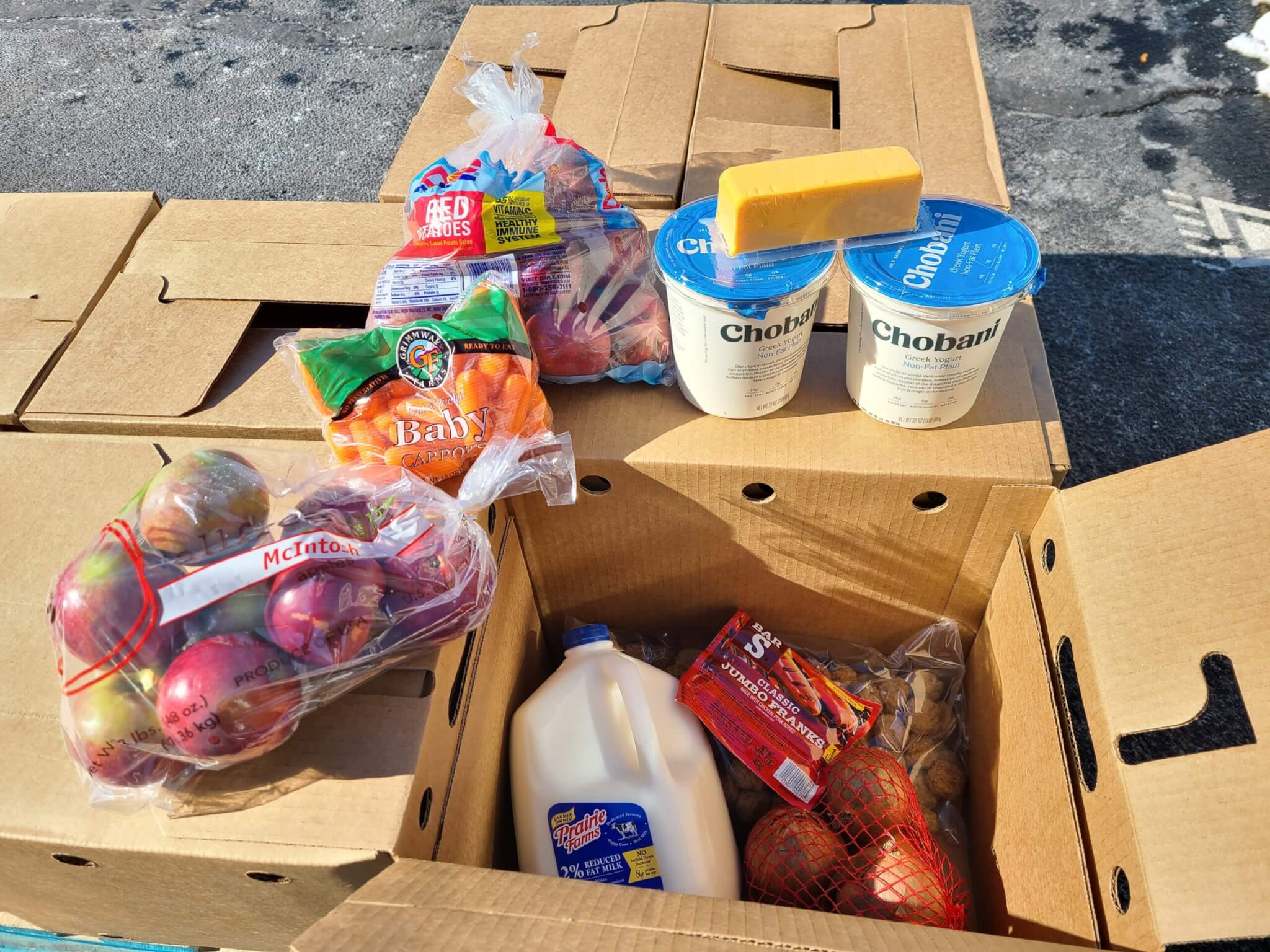 Food boxes with a combination of meat, produce and dairy items