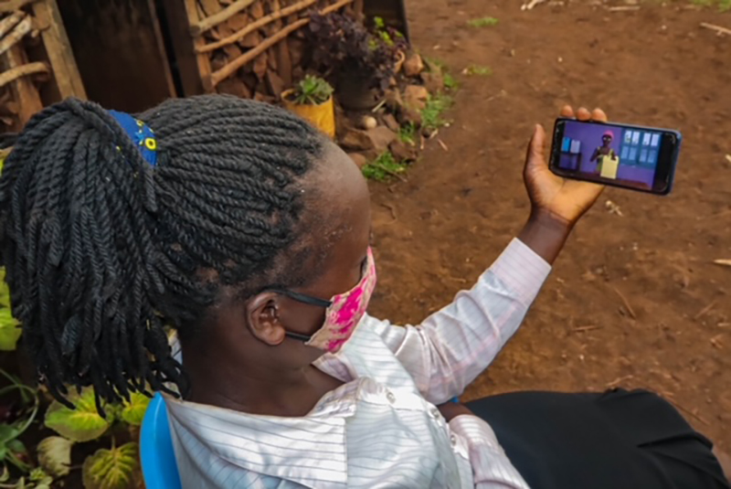 Child looking at phone, Photo provided by SAWBO
