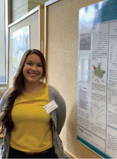 Katherine Rivera-Zuluaga close to her research poster