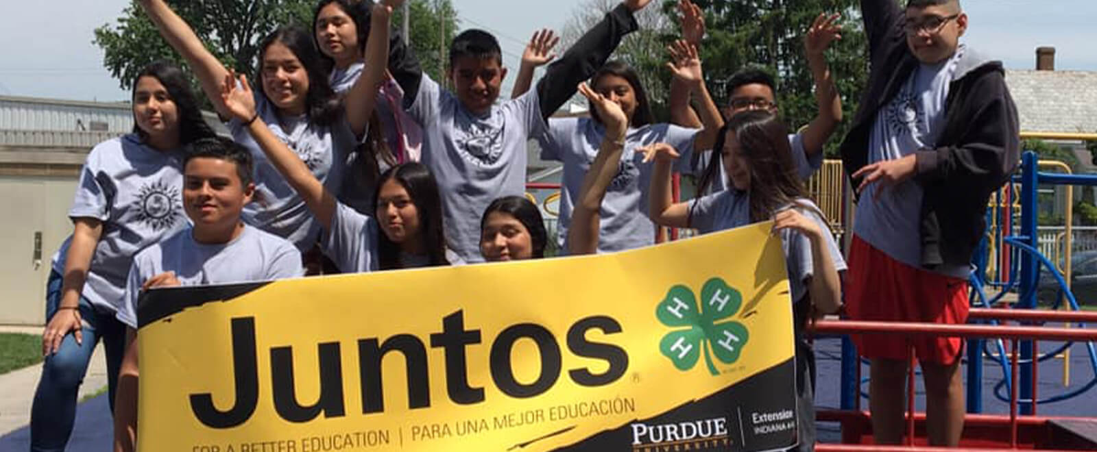 Juntos student group holding a banner