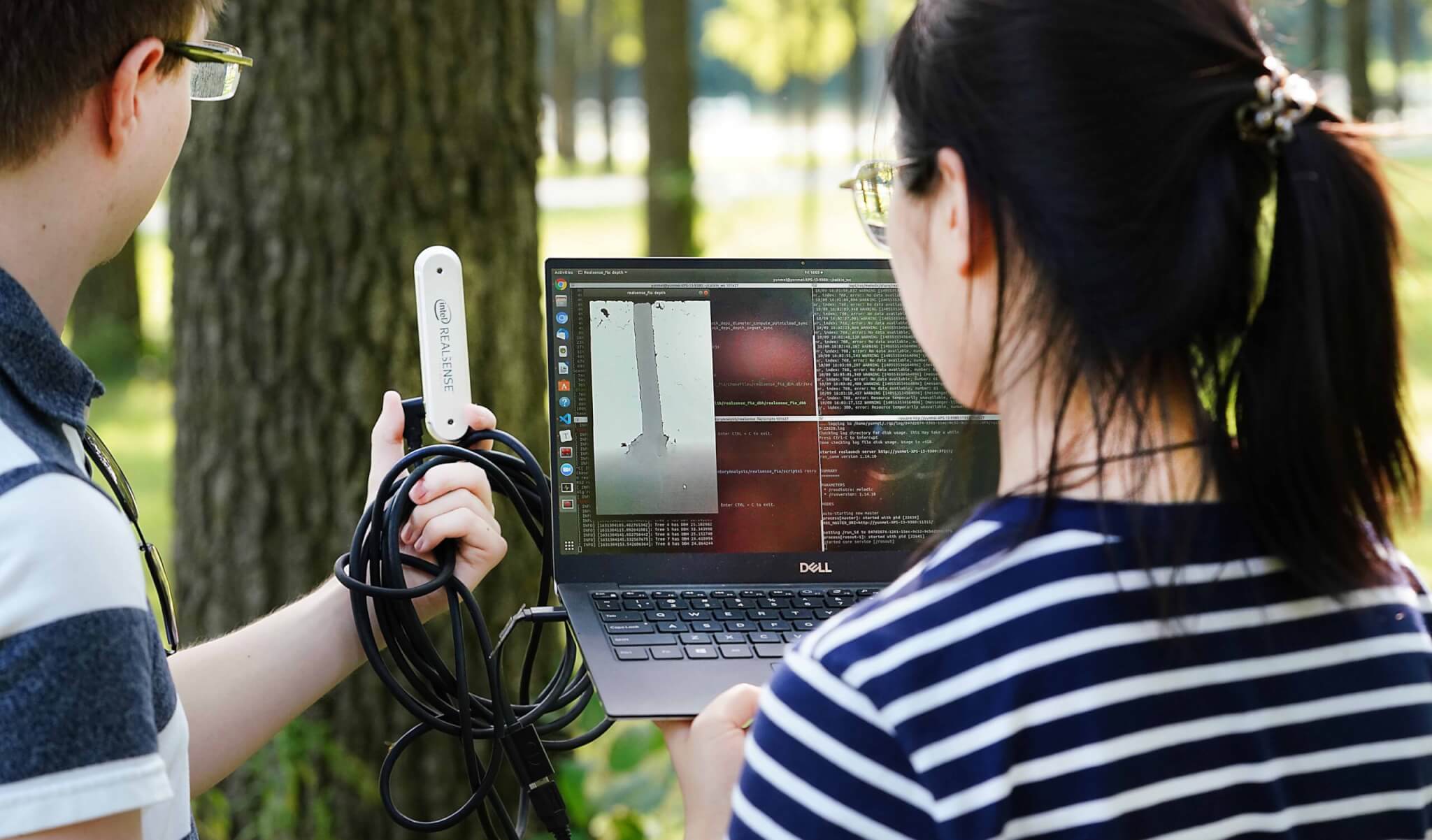 Nick John Eliopoulos (left) and Yunmei Huang (right) of the VIP program scan trees at Martell Forest. 