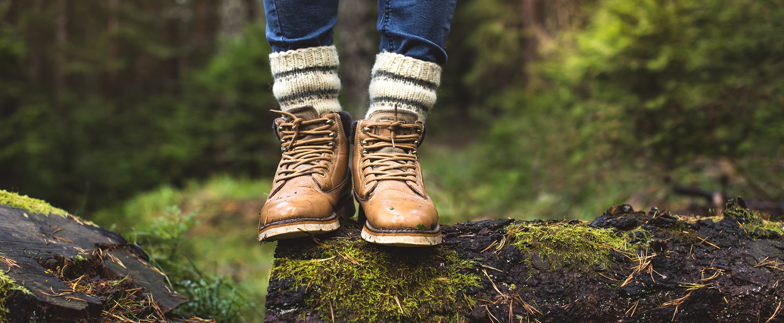 Hiking boots on a mossy log