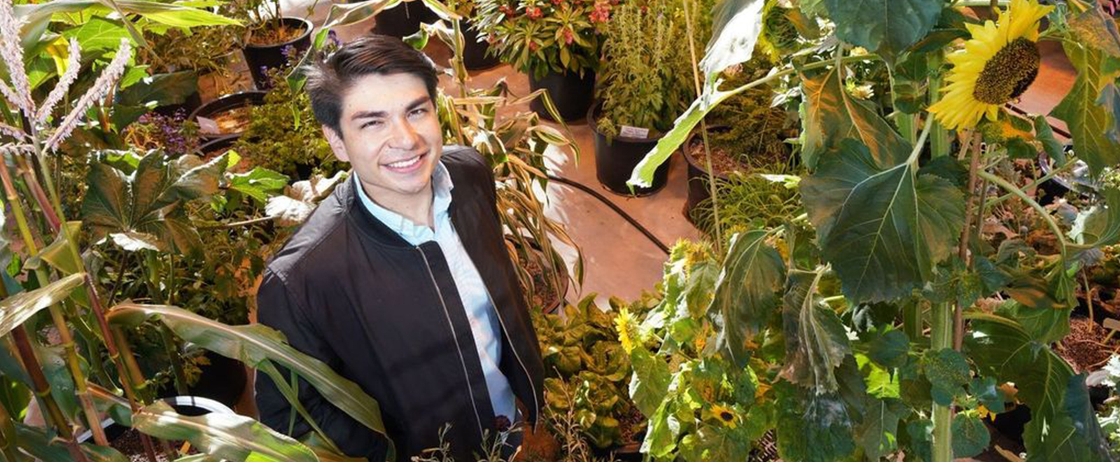 Enrique Velasco surrounded by plants