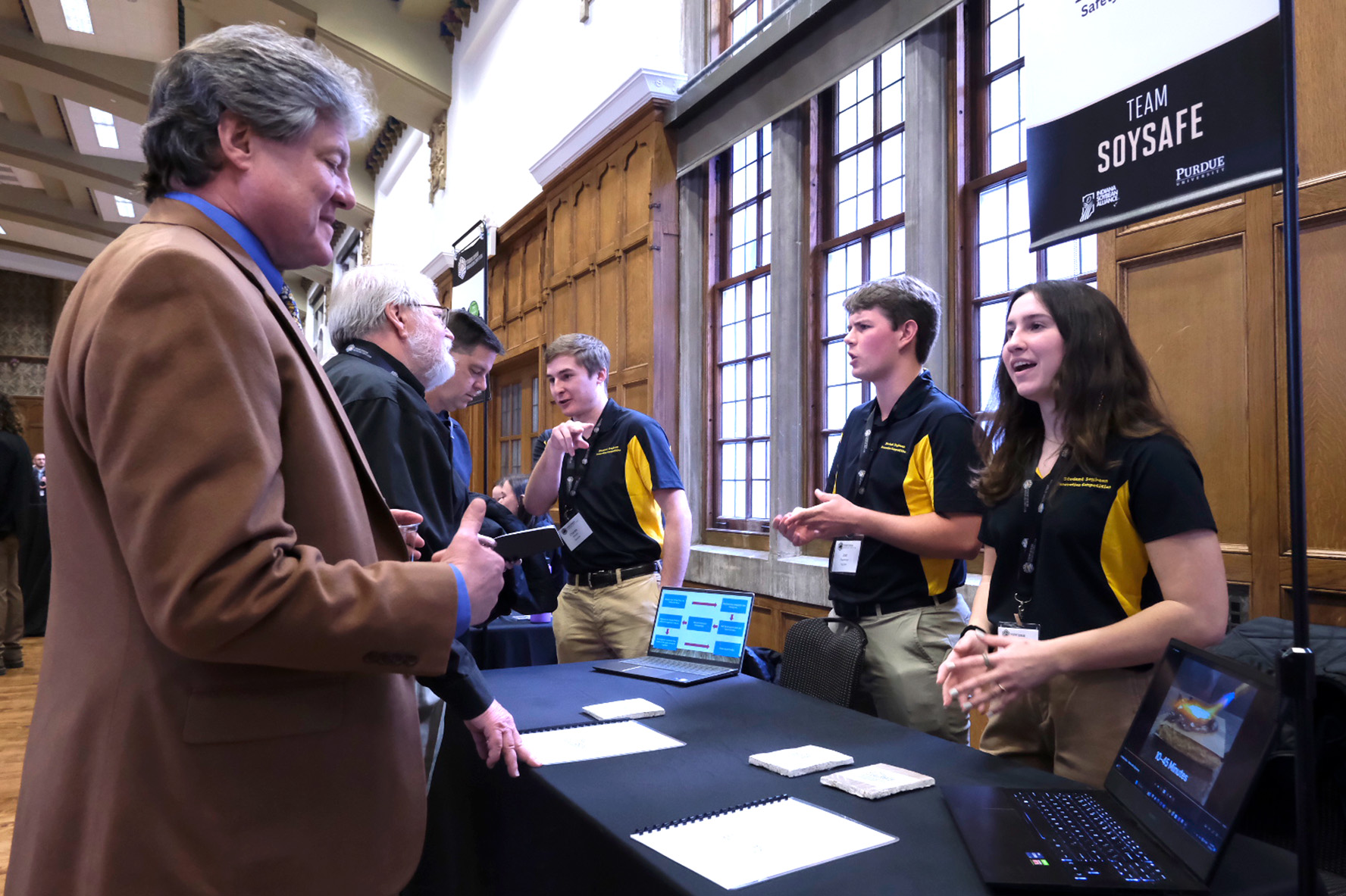 Guests visit booths at soybean competition at Purdue