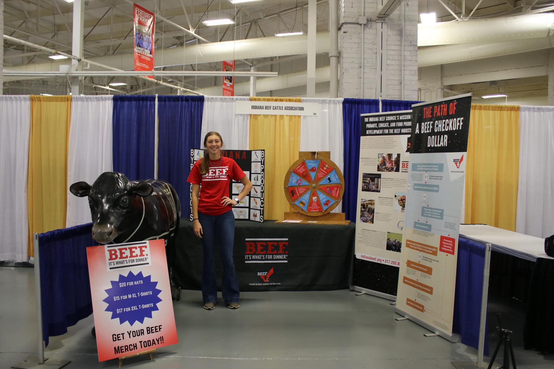 Ellie Staggs stands in front of the Indiana Beef Cattle Association's booth at the Indiana State Fair.