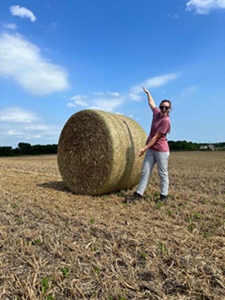 Sydney Wheeler next to a hay bale
