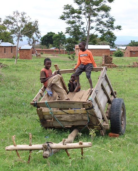 Young Tanzanians hang out together on a cart.