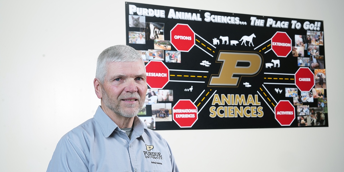 Jeff Fields in front of a Purdue sign