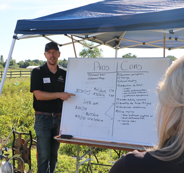 Meyers demonstrates some research outside during a field day to the public