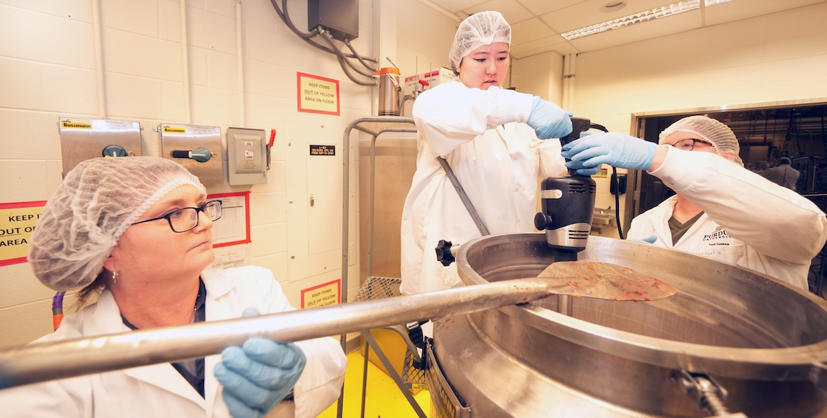 Students blend products within the facilities of the Skidmore Lab, housed in the Nelson Hall of Food Science.
