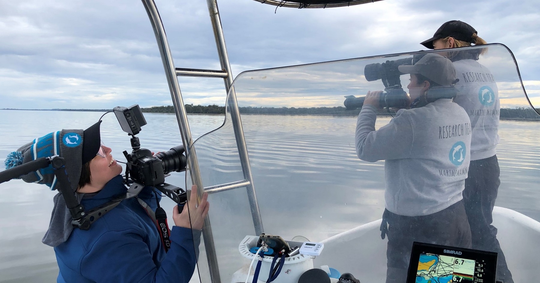 FNR alumna Olivia Andrus-Drennan films researchers on a boat at sea