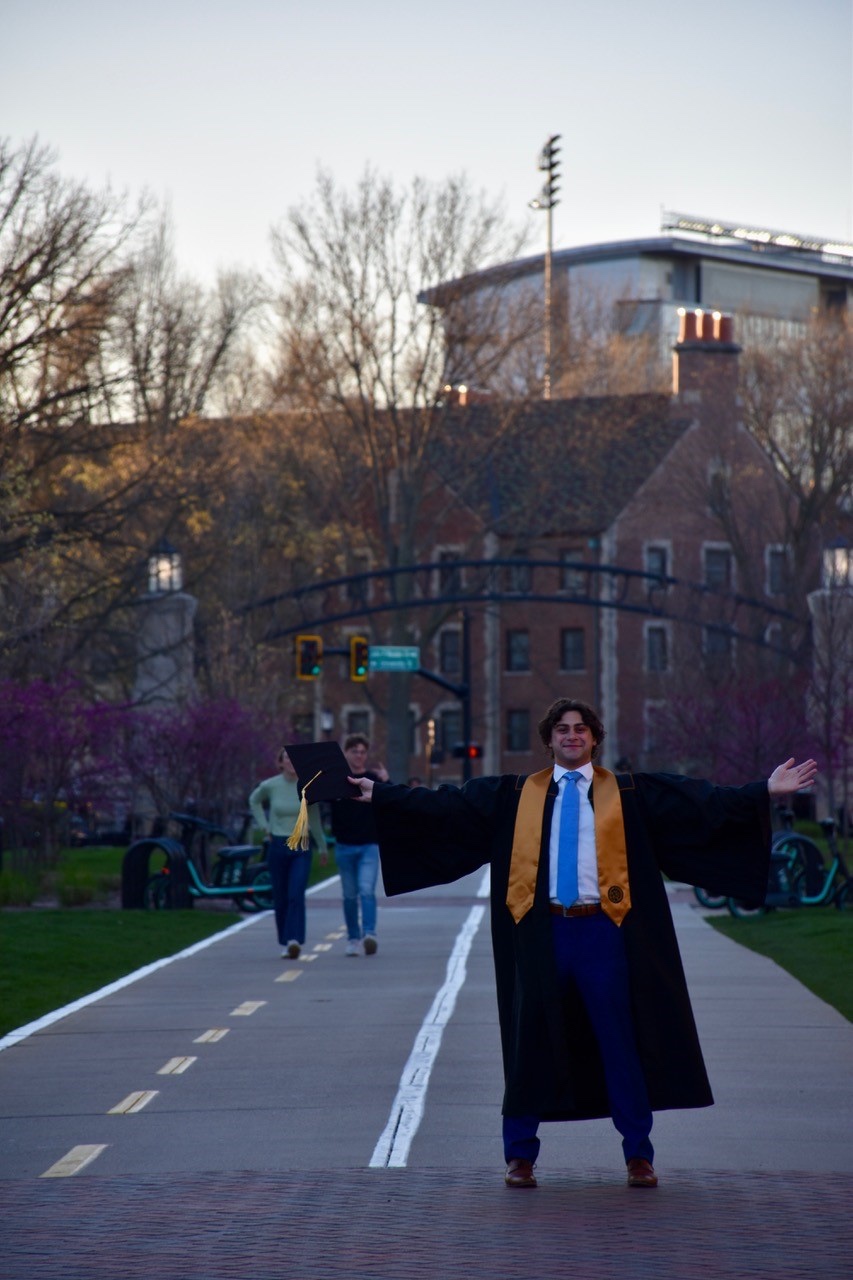 Remi Carrella stands at Purdue in cap and gown