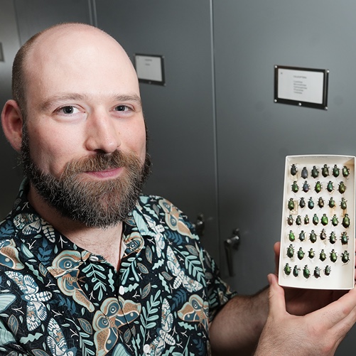 Chris Wirth holding bug specimen