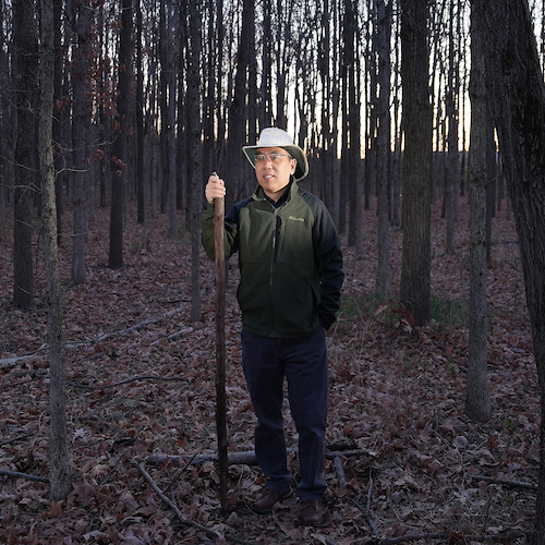 Songlin Fei, director of Purdue’s Institute for Digital Forestry and professor in the Department of Forestry and Natural Resources, standing among the trees in Martell Forest.