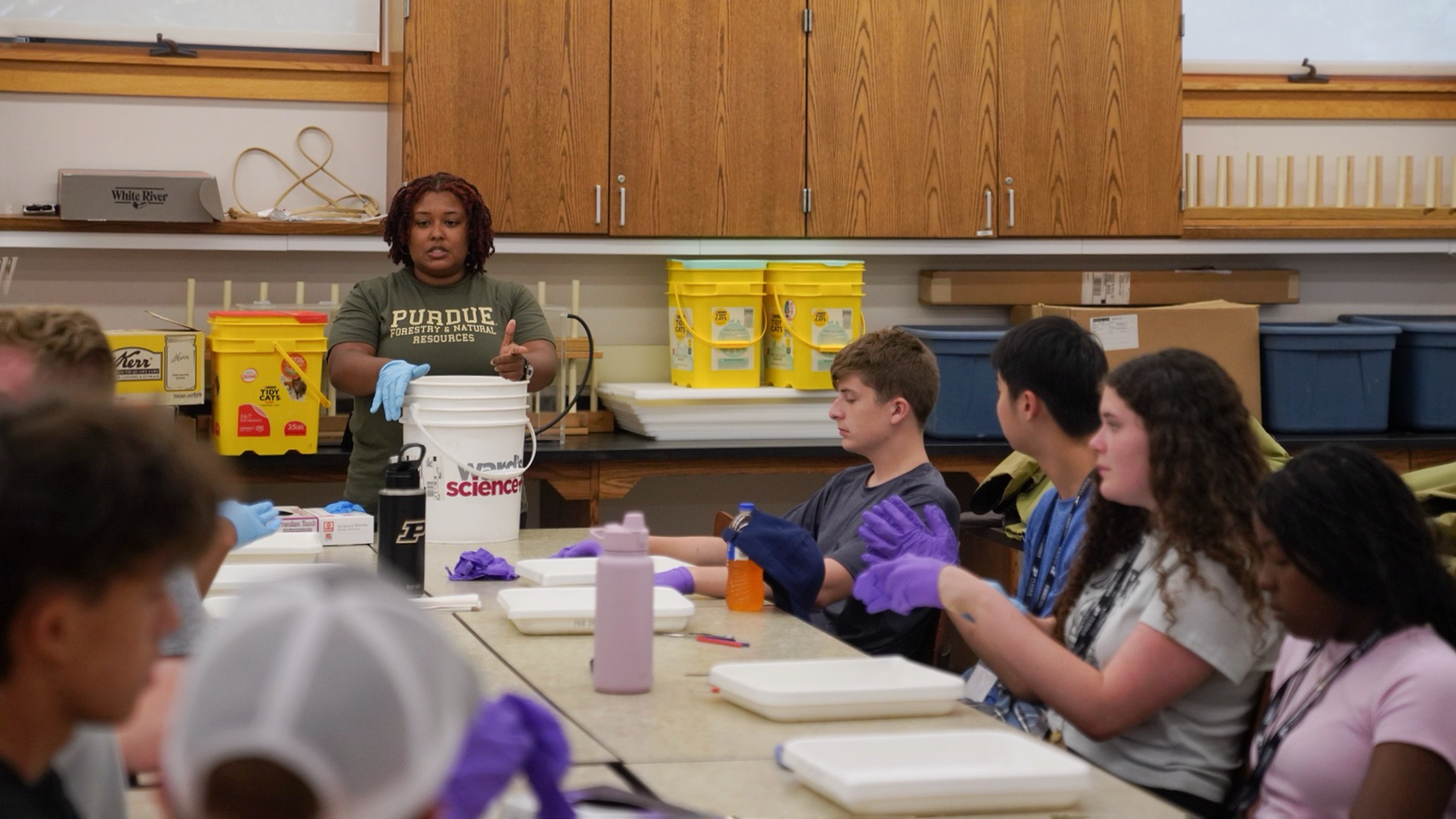 Megan Gunn instructing C-PASA students in the front of a lab