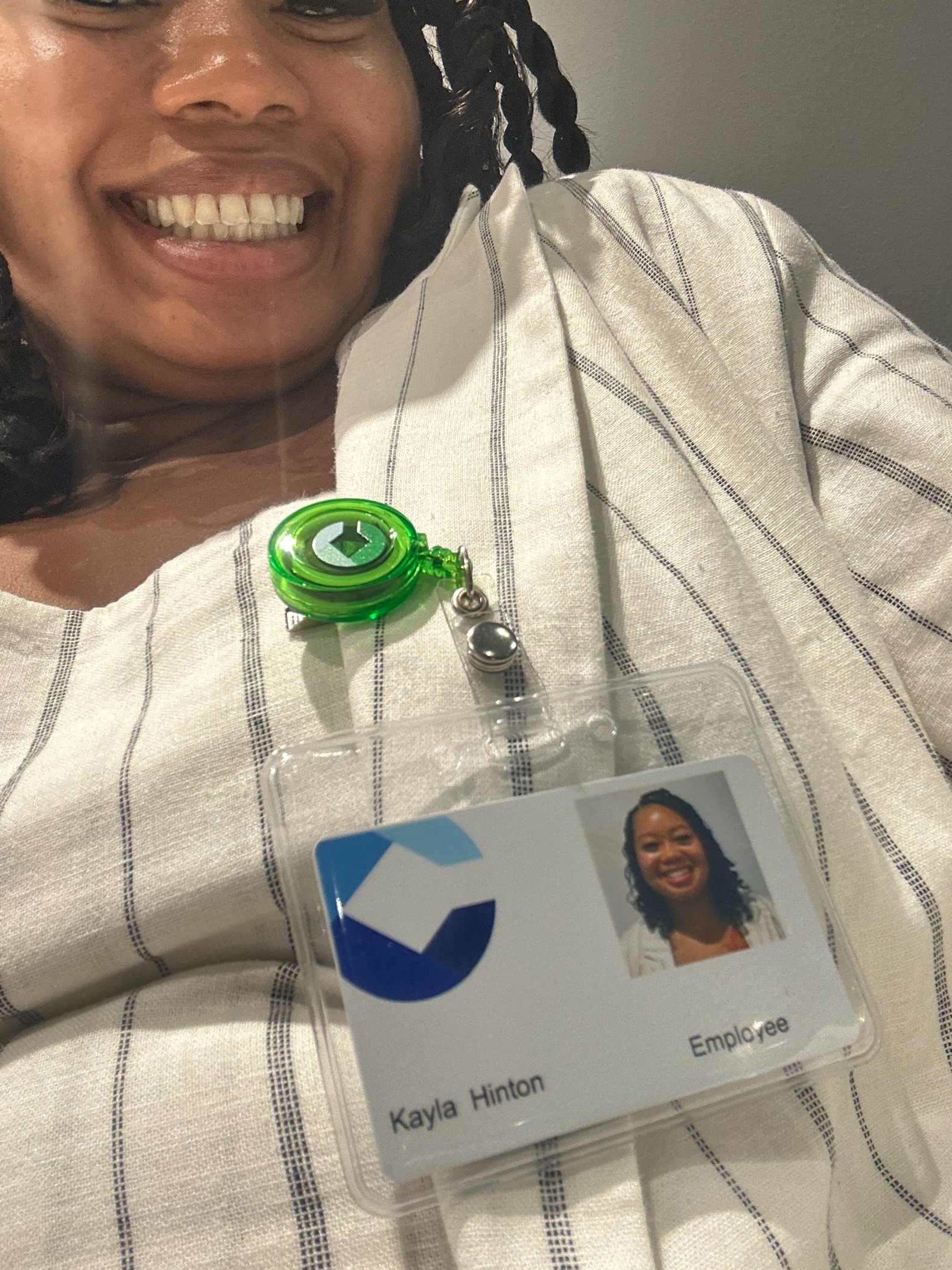 Kayla Hinton smiles with her employee badge