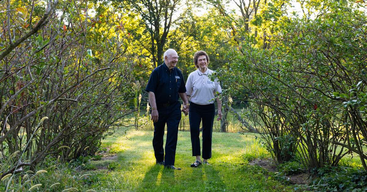 Marshall and Berdine Martin walk hand in hand at their family farm