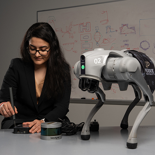 Upinder Kaur, assistant professor of agricultural and biological engineering, works on a robot dog that finds ticks and identifies tick activity.