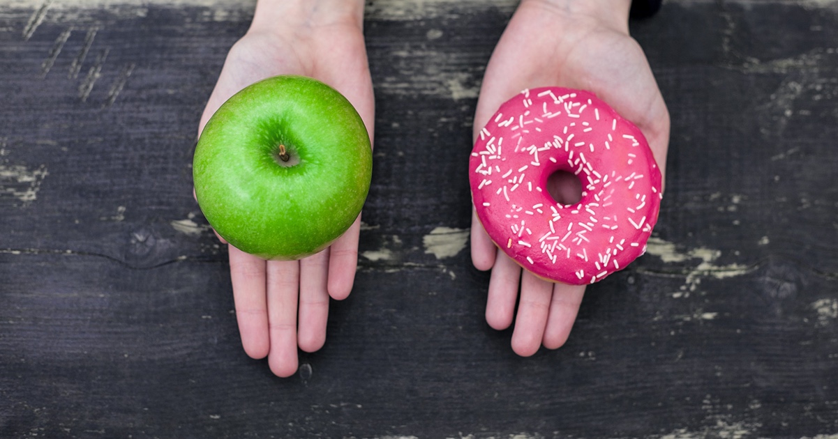 photo of apple and donut in hands