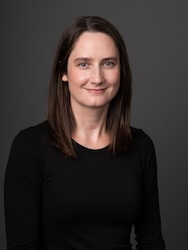 Portrait of Carolyn Burt in front of grey backdrop.