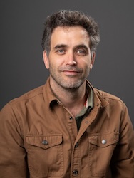 Portrait of Clement Bataille in front of grey backdrop.