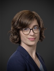 Portrait of Ellen Van Loo in front of grey backdrop.