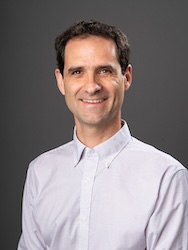 Portrait of Jonathan Bauchet in front of grey backdrop.