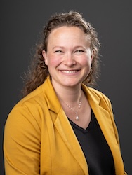 Portrait of Julie Mahoney in front of grey backdrop.