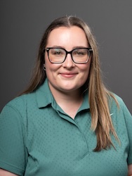 Portrait of Megan Bourns in front of grey backdrop.