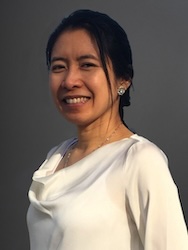 Portrait of Patnarin Benyathiar in front of grey backdrop.