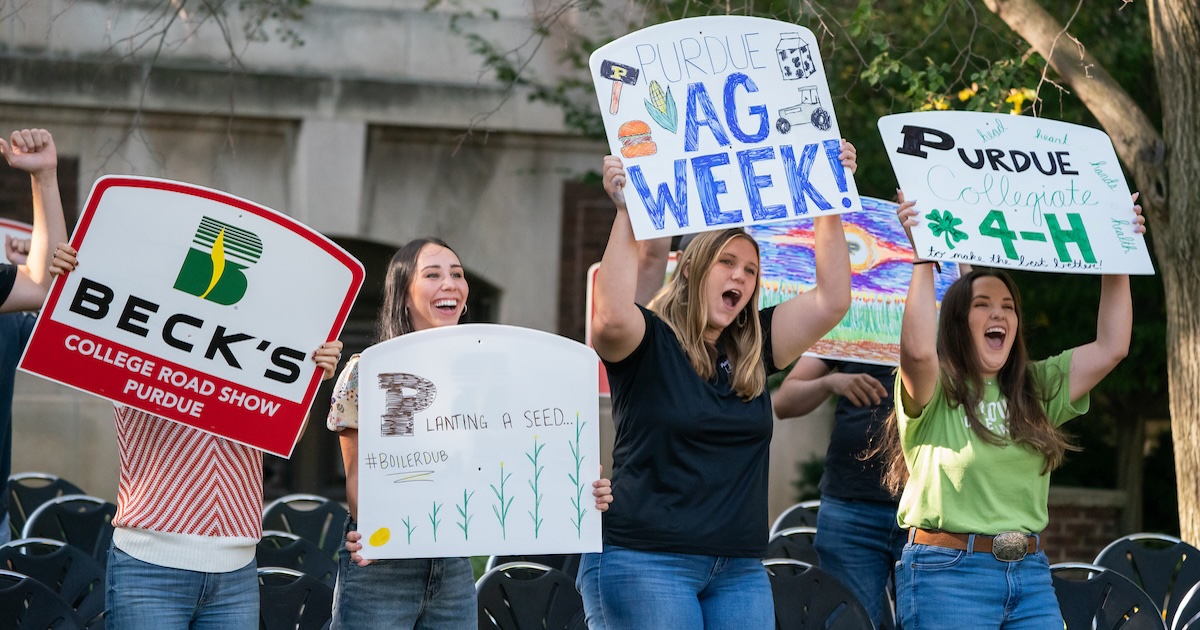 Purdue ag students holding signs at the 2024 AgDay College Roadshow.