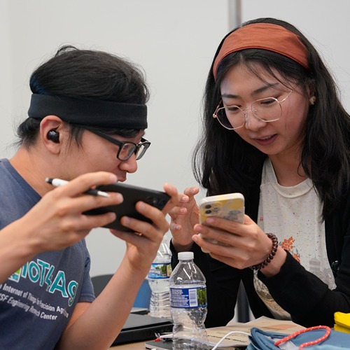 Agbridge participants standing as a group or working together from their phones
