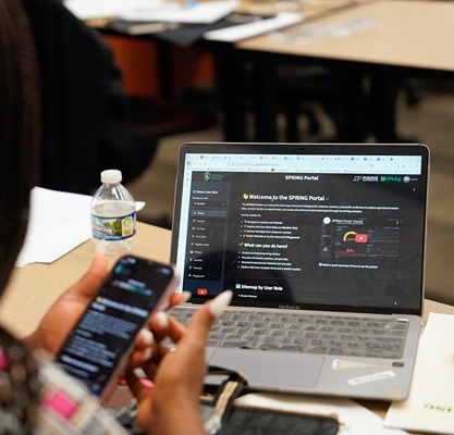 agbridge participant scrolls through a dashboard on her phone and computer