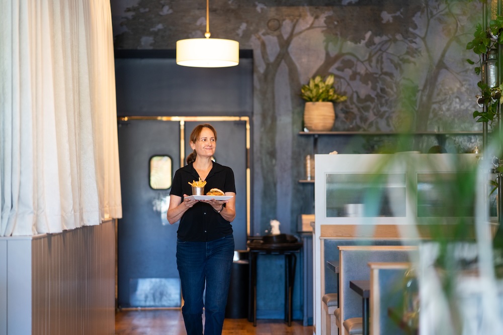 CD Young serving plant-based food in her restaurant, Spirit Elephant. 