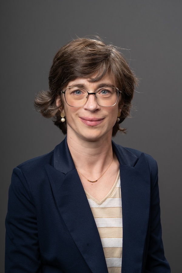 Headshot of Ellen Van Loo in front of grey backdrop.
