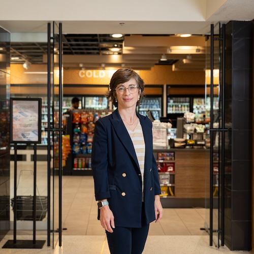 Ellen Van Loo standing in front of the entrance to the Boilermaker Market.