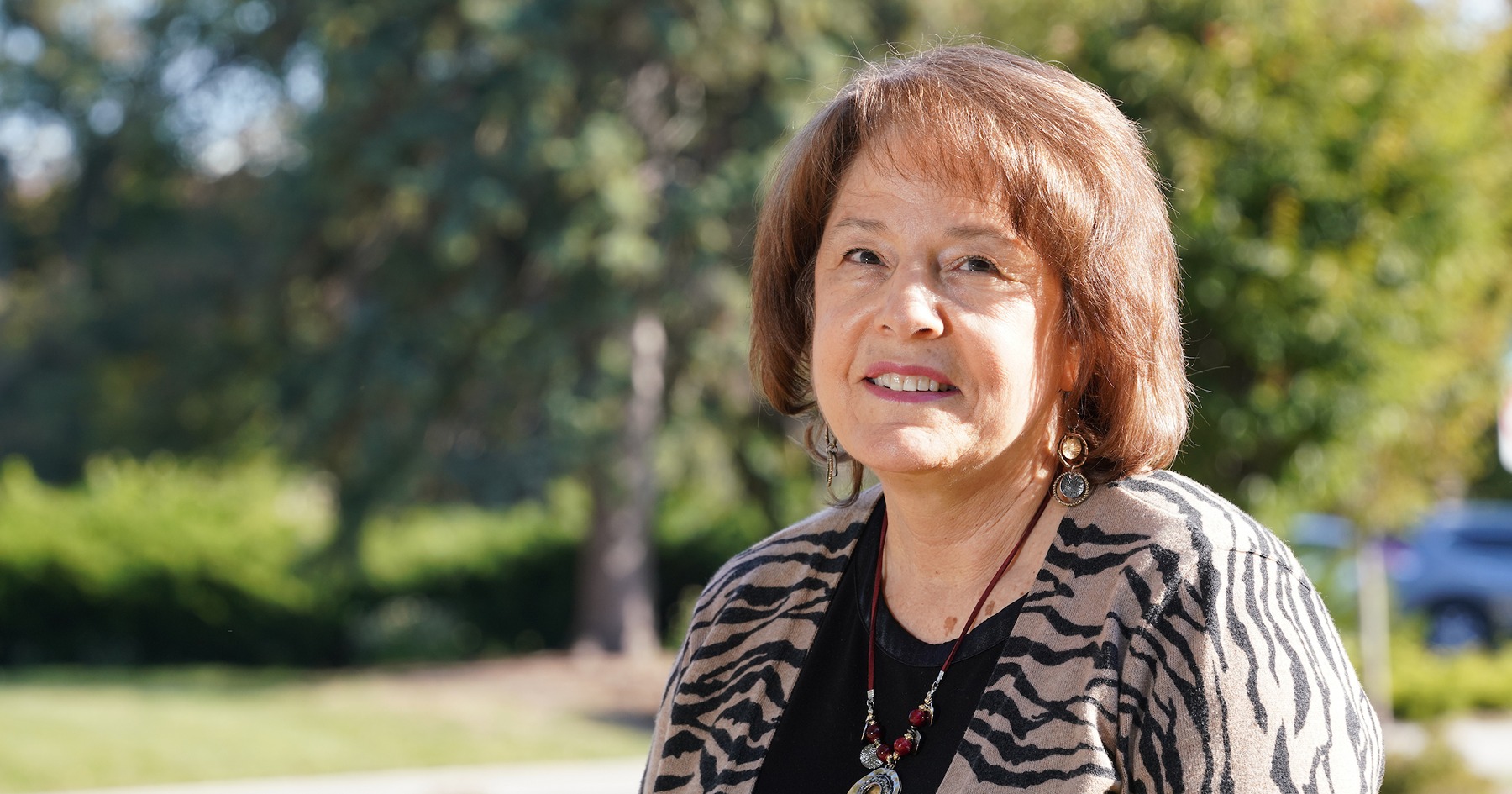 Linda Lee in front of trees