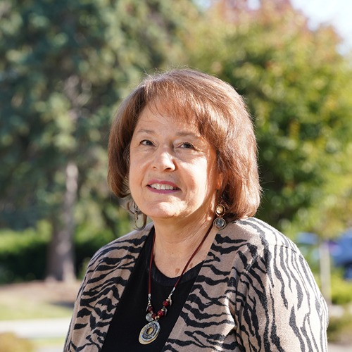 Linda Lee in front of trees