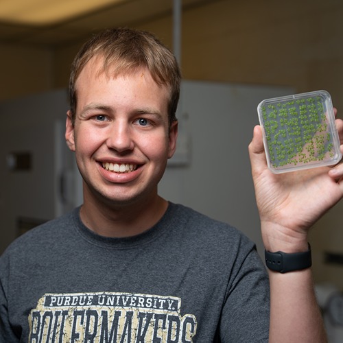 Blaine Wagner poses with laboratory equipment