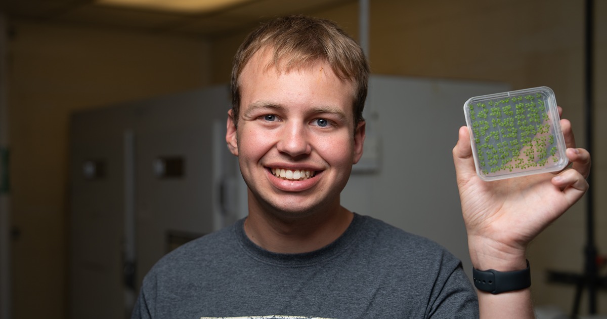 Blaine Wagner poses with laboratory equipment