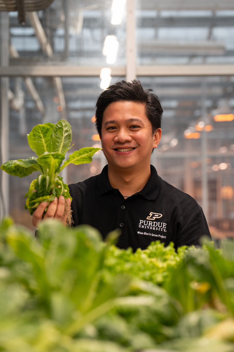 Jemuel in greenhouse working.